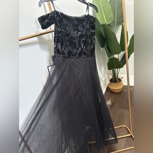 High-low dress. Off the shoulder, sequined top and flowy skirt.